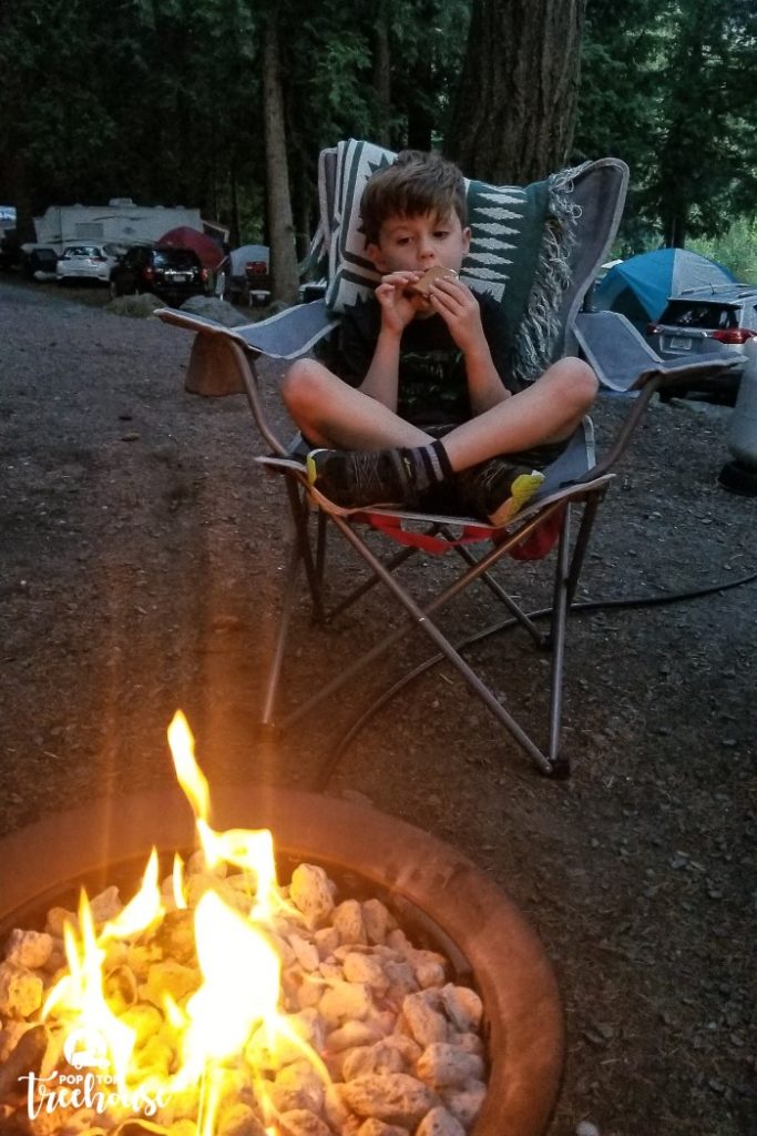 kid eating smores by the camping fire